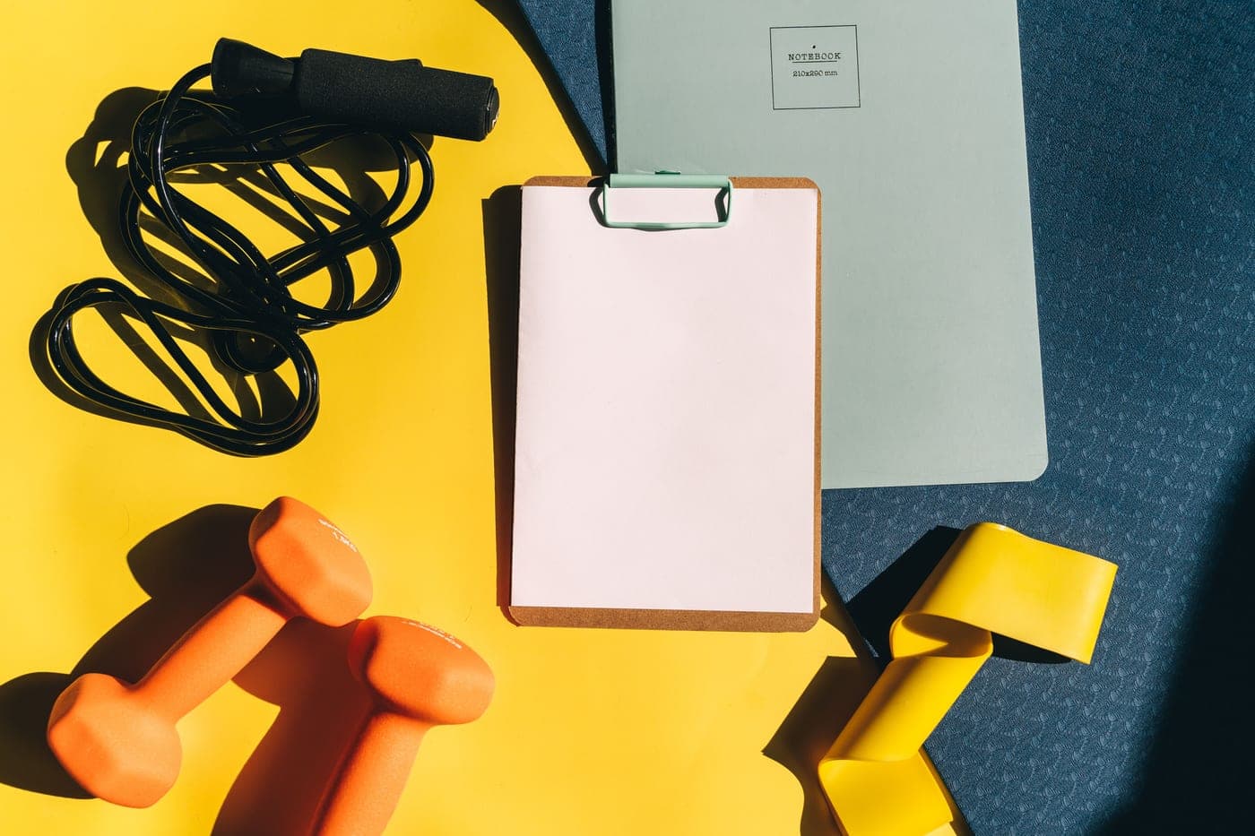 A home-gym planning notebook and equipment